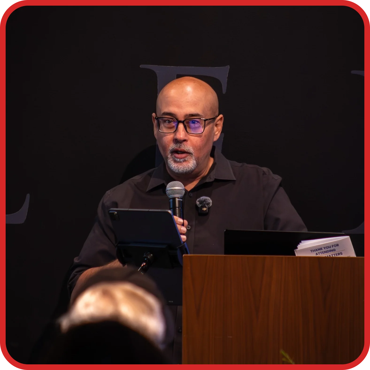 Ki Siadatan speaking at a podium